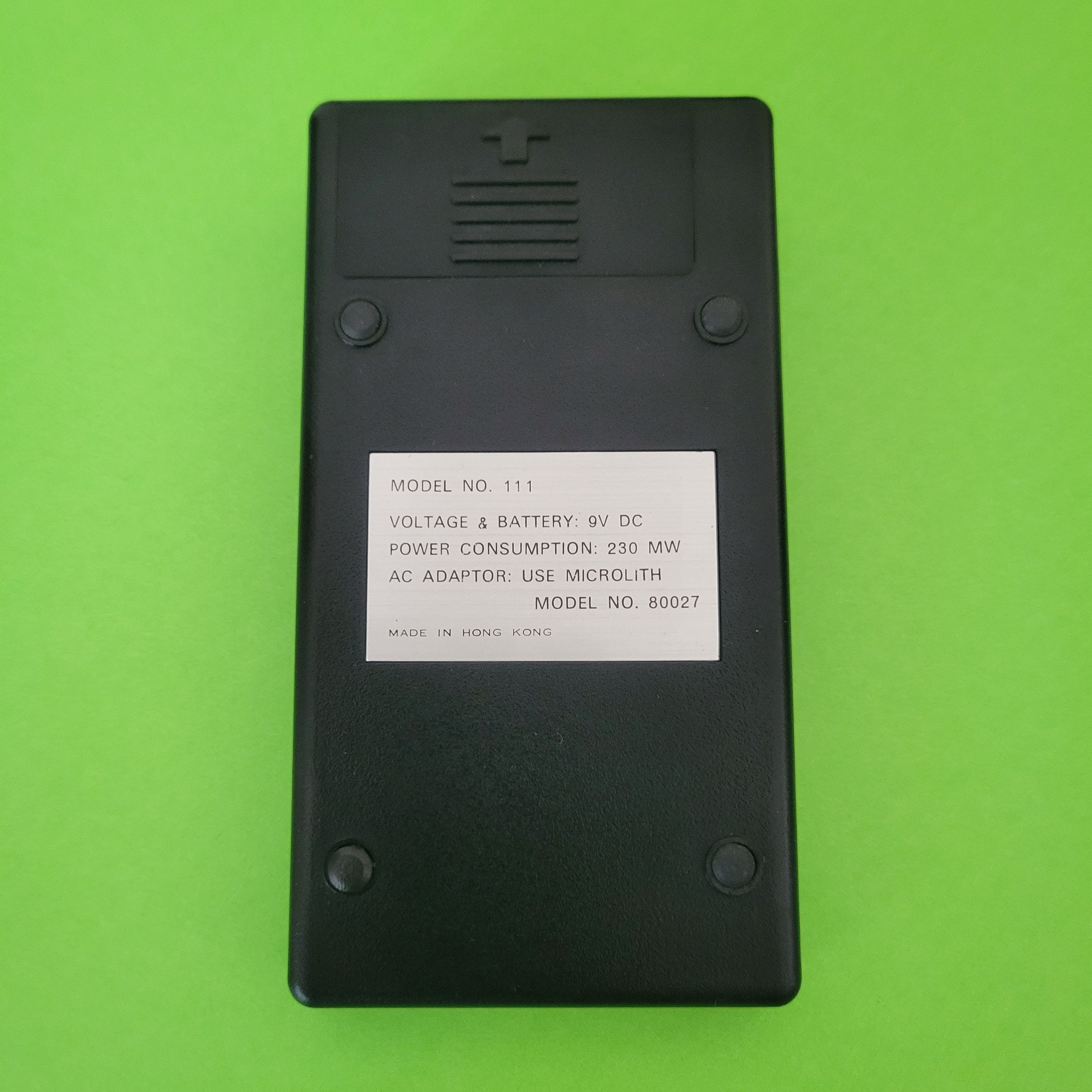 An image of the back of a Microlith Four function plus calculator
